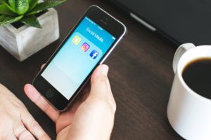 Social Media Services icons are displayed on a smart phone screen