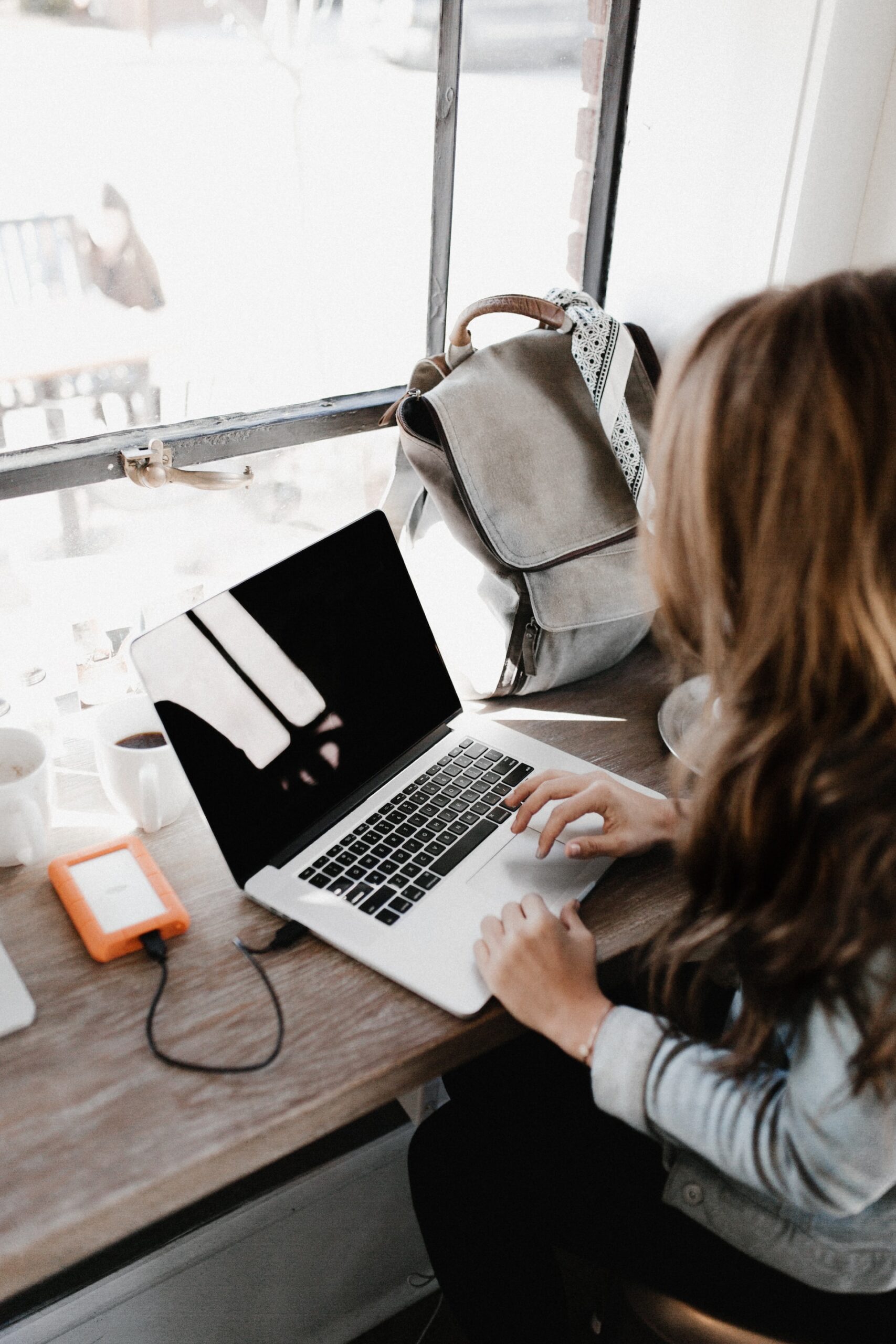 woman at open laptop with a blank screen